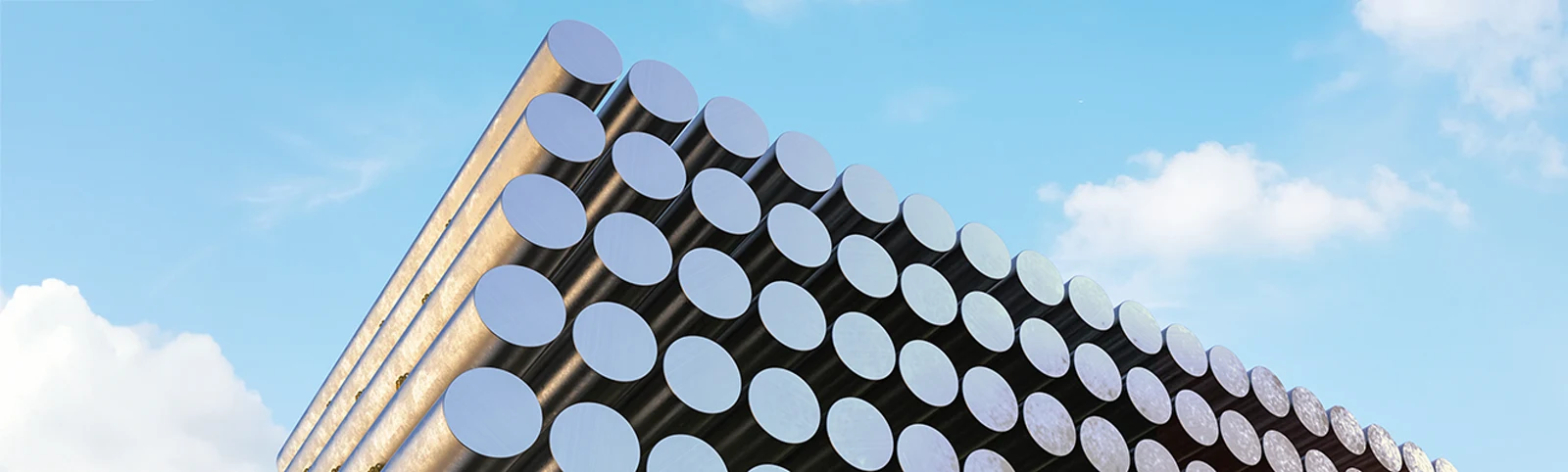 Aluminium extrusion billets stacked against open sky